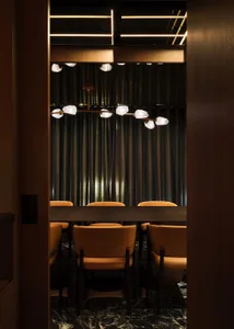 A modern restaurant interior featuring marble elements and industrial design.