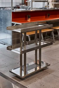 Industrial metal food cart with three shelves on wheels.
