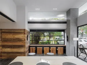 Modern cafe bar with wood and concrete materials.