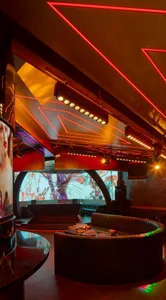 Modern nightclub lobby featuring metallic accents and a glass panel