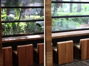 A cozy cafe interior featuring wooden benches and large windows allowing natural light to fill the space.