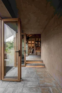 A minimalist restaurant interior with stone and wood elements, showcasing modern design and natural materials.