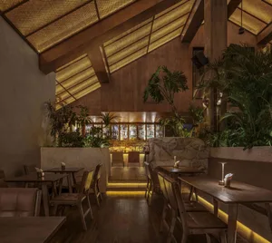 Contemporary restaurant interior with wooden decor and stone detailing.