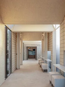A modern restaurant with minimalist design features concrete and glass material.