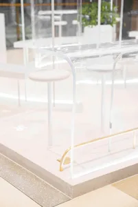 Clear acrylic restaurant counter with modern design and seating.