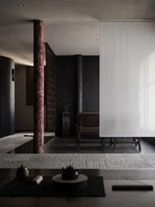 A minimalist residential space featuring a wooden cabinet and stone floor.