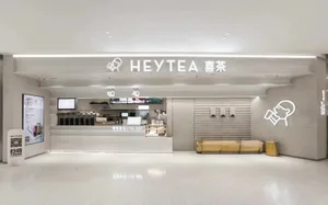 Modern restaurant interior with minimalist design featuring predominantly white materials.