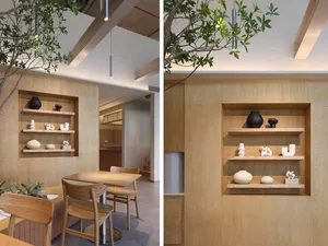 A minimalist interior design featuring wooden shelves with various decorative items.