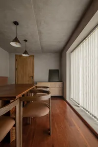 Modern dining room featuring wooden furniture and flooring.