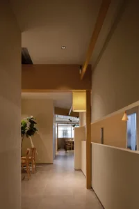 A modern interior corridor with concrete tiles and minimalist lighting fixtures.