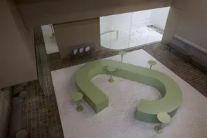 An industrial-style corporate lobby area with a concrete floor and minimalist design.