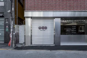 Closed storefront with metal shutters and glass windows