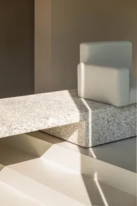 Modern minimalist interior featuring stone furniture and clean lines.