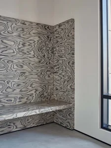 Modern industrial style interior design featuring a corner bench with a wood-patterned panel