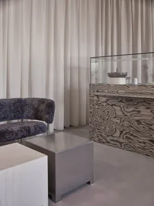Modern office interior featuring minimalist design with metal and textile elements.