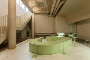 Modern office space featuring concrete walls and floors.