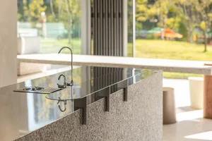 Modern kitchen featuring granite countertops and stainless steel fixtures.
