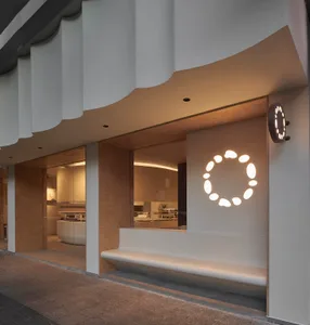 A modern retail storefront with a white circular light feature in the window.