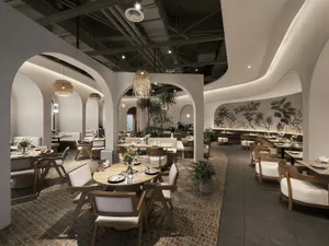 A modern restaurant interior featuring white walls, wood furniture, and ceramic tiles.