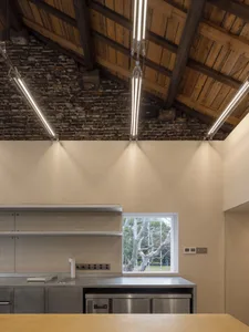 An industrial-style kitchen featuring metal countertops and wooden accents.