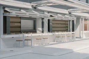 A modern bar counter space featuring metal stools and wood seats.