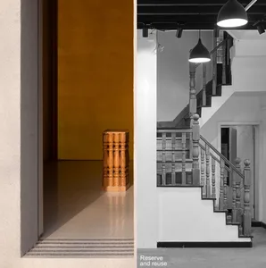 Modern interior space with a wooden staircase and yellow wall.