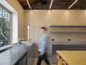 Industrial-style modern kitchen with metallic countertops and minimalist design