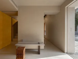 Modern minimalist interior design featuring a sleek, minimalist concrete bench and a compact, functional seating area.