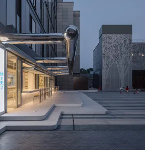 A modern public space featuring concrete and glass materials.