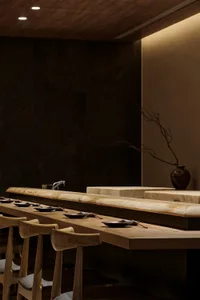 A modern restaurant bar featuring wooden furniture and minimalistic design elements.