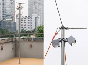Metal post with two spotlights suspended by orange ropes in an outdoor setting.