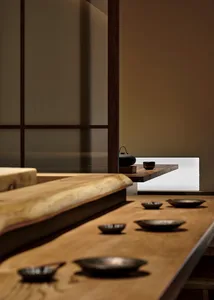 A traditional wooden food service counter with bowls and utensils arranged on it.