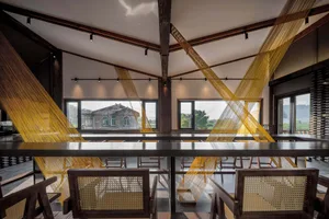 Modern cafe interior with wooden materials and industrial design elements.