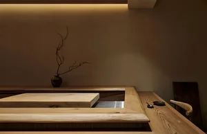 Modern restaurant interior with wooden seating and minimalist decor.