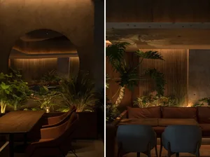Industrial-themed restaurant seating area with concrete and wood materials.