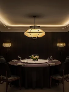 A well-lit, modern restaurant dining room with wooden paneling, a round table, and elegant decor.