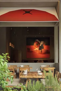 A modern restaurant interior with wooden furniture and an orange awning.