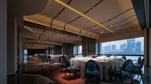 A modern restaurant interior featuring fabric seating, glass windows, and wooden accents.
