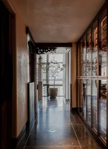 Modern corridor featuring concrete flooring, marble accents, and wooden beams.