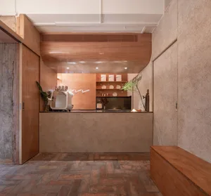 Modern coffee shop interior with a marble counter and wooden accents.