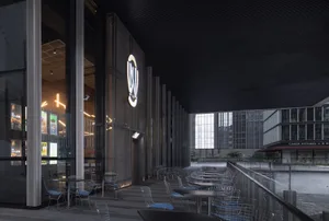 Modern restaurant exterior featuring metallic design, glass walls, and concrete base.