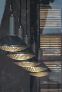 Hanging industrial-style lighting fixtures arranged in a linear pattern