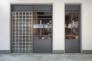 The storefront features a modern glass design.