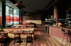 Modern restaurant with wooden tables and concrete walls