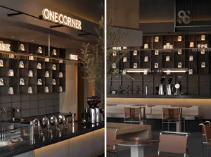 A modern coffee shop interior featuring sleek metal fittings, wooden accents, and glass display cabinets.