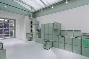 A minimalist storefront featuring green paneling.