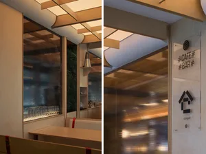 Interior design photograph of a modern cafe and bar featuring wooden materials and lighting.