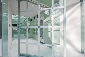 A modern commercial space featuring glass walls and panels.
