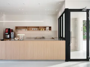 Contemporary coffee bar with wooden counter and minimalist design.