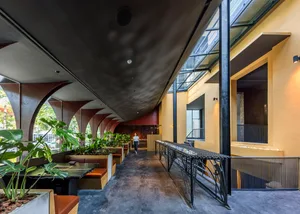 Modern industrial restaurant interior with concrete and glass elements
